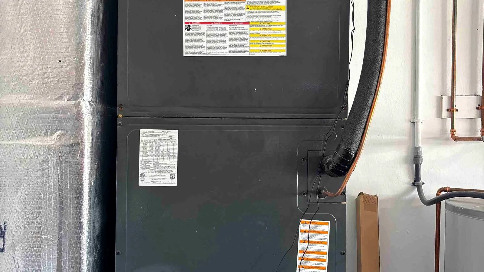 Amana air handler installed in a utility closet with insulated line set and ducted return