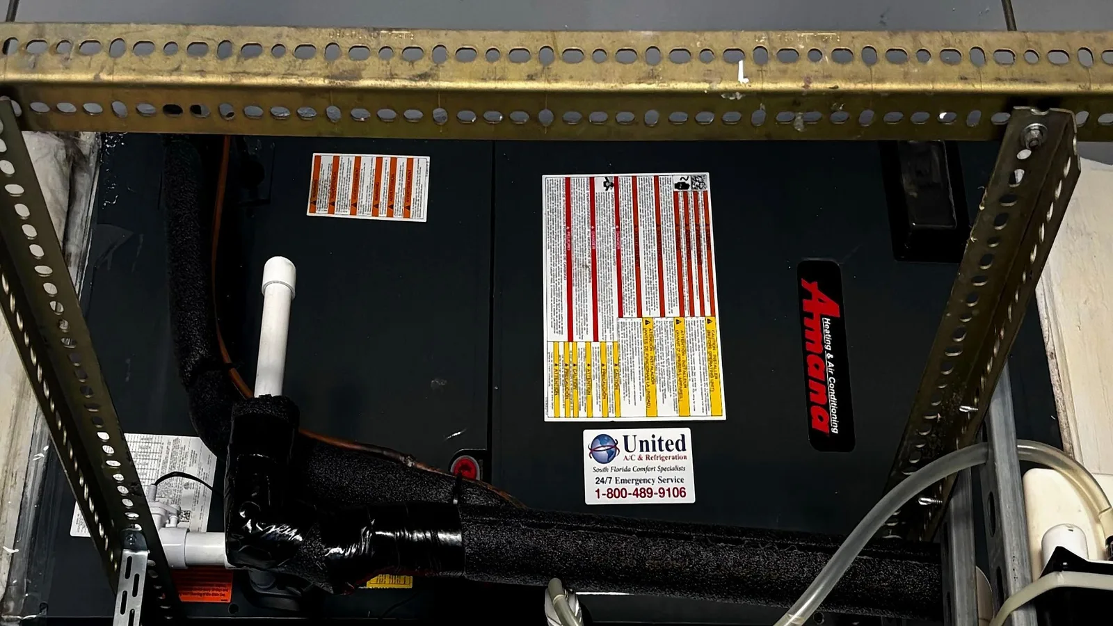 Suspended Amana horizontal air handler on strut hangers with insulated line set and condensate drain