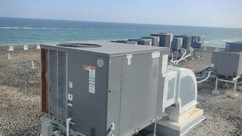 Packaged rooftop air conditioning unit on an oceanfront roof with condensate and refrigerant lines