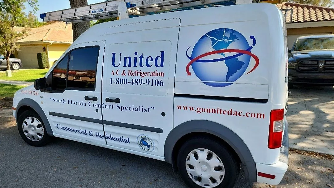 United A/C and Refrigeration van with extension ladders parked at a service call