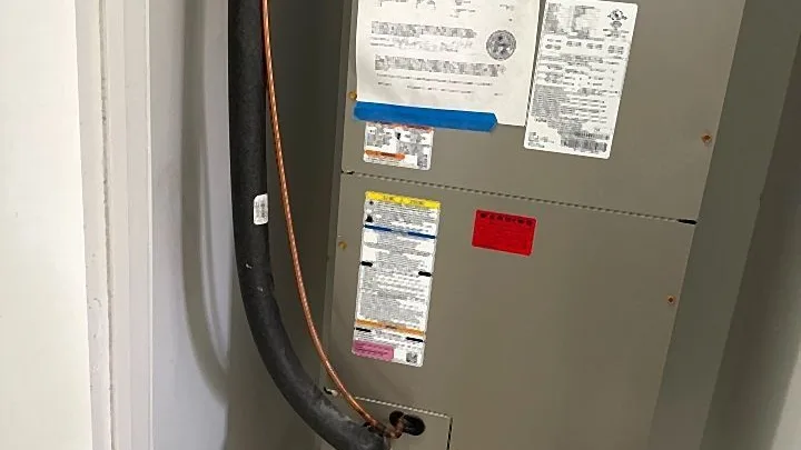 Air handler in a closet with charging chart and a properly built PVC condensate trap