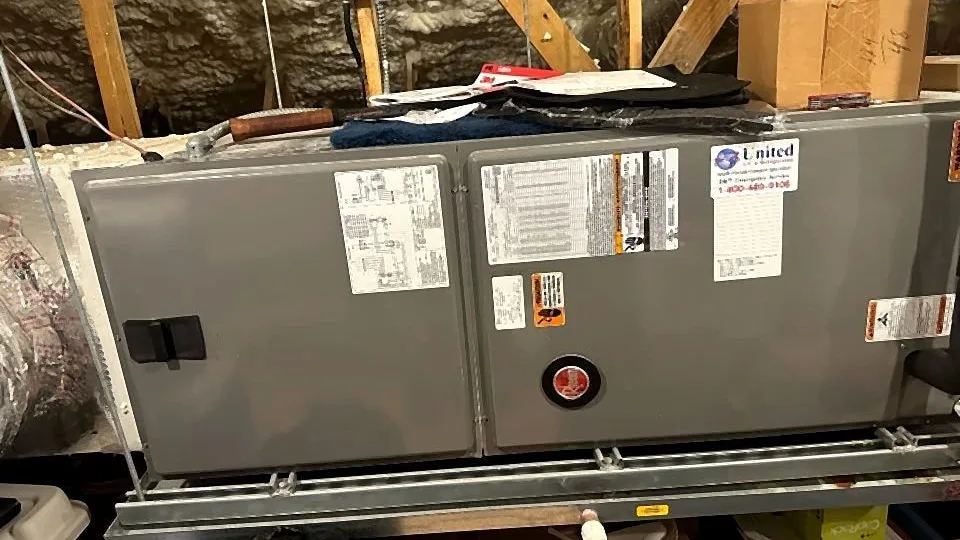 Horizontal attic air handler suspended on a steel rail with refrigerant lines and disconnect