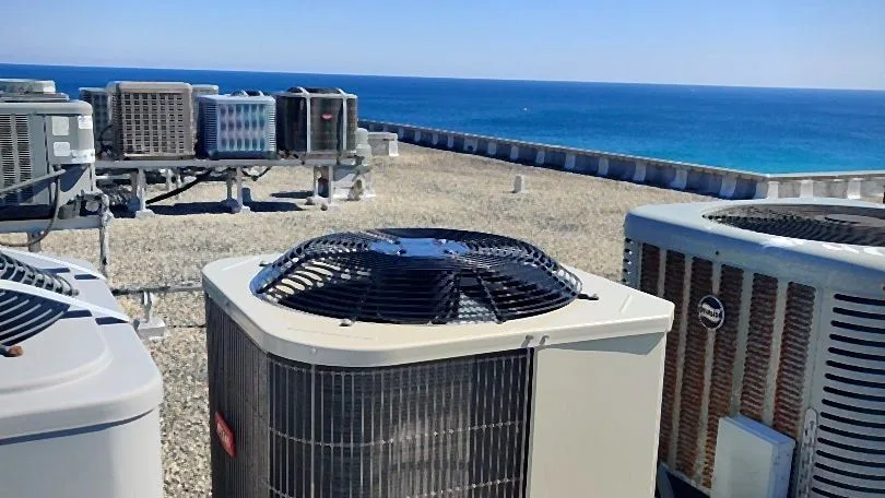 Rooftop air conditioning units on a gravel roof above the open ocean