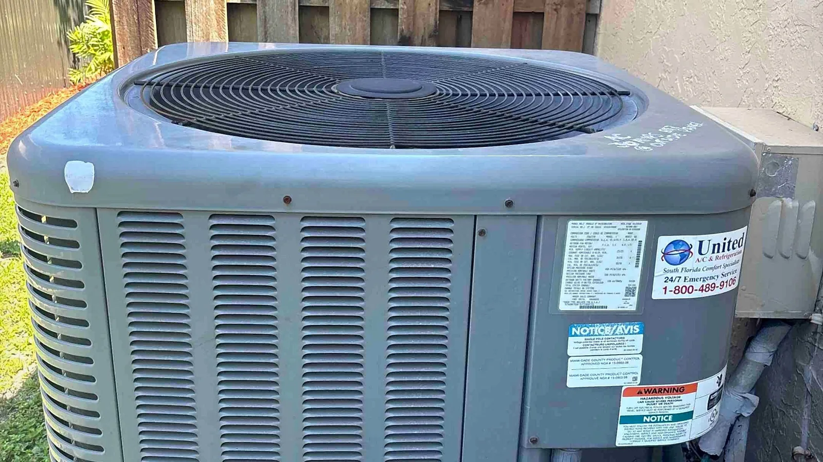 Condenser mounted on a hurricane-rated equipment pad with code-approved labeling