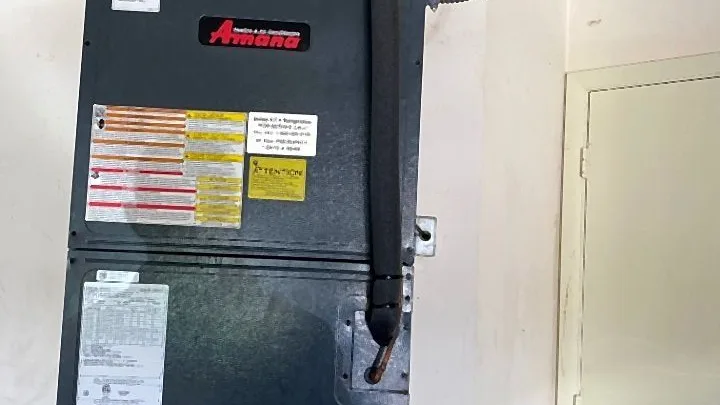 Amana indoor air handler installed in a closet with insulated refrigerant lines