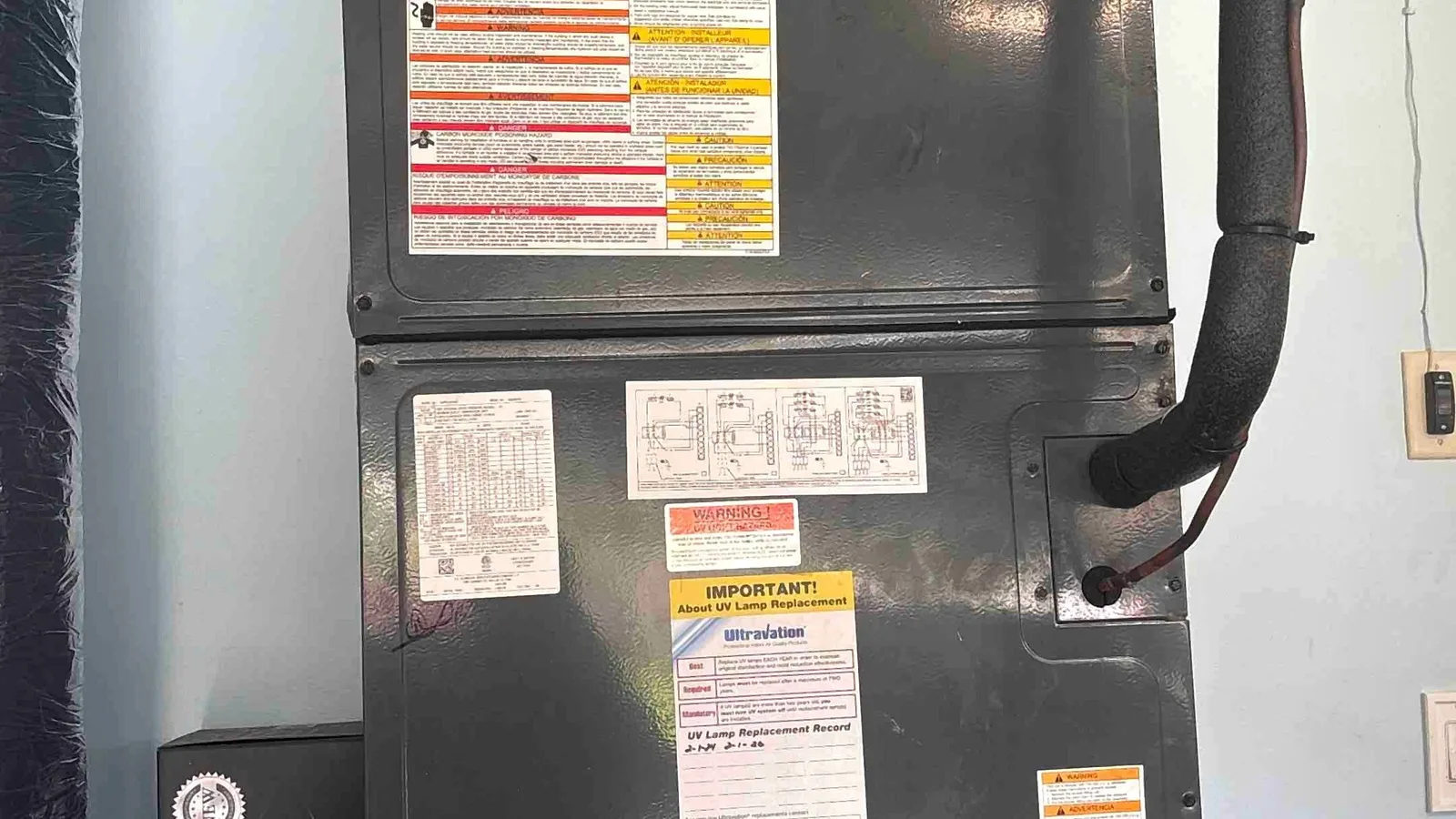 Air handler fitted with a UV lamp and a handwritten lamp replacement service record