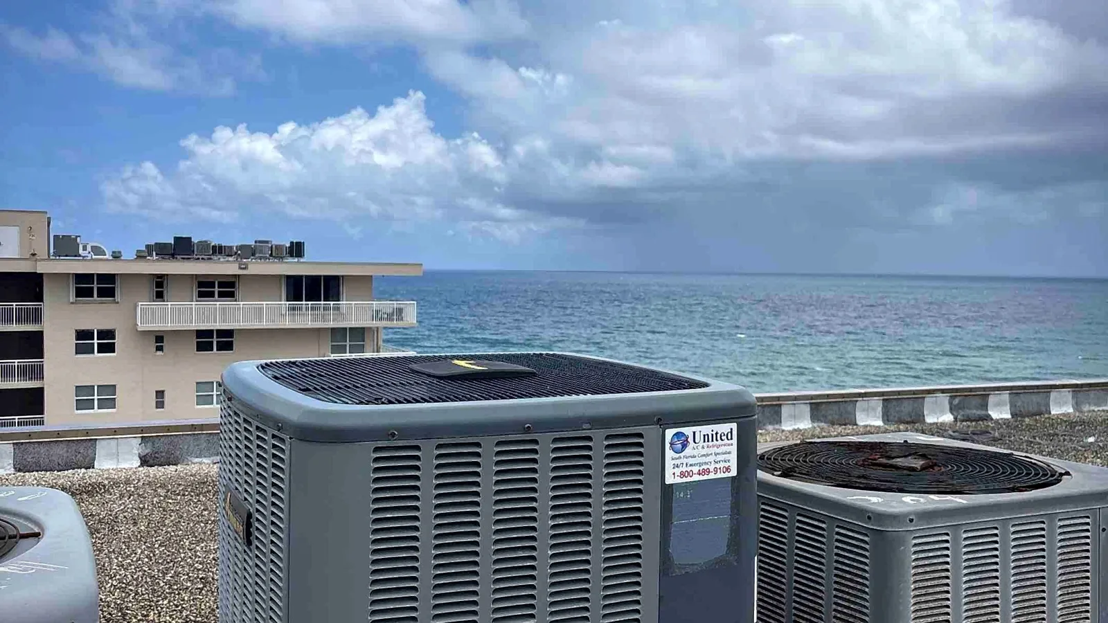 Oceanfront rooftop air conditioning condensers overlooking the water at a condo building