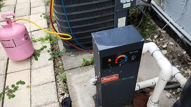 Manifold gauges and refrigerant recovery cylinder connected to a condenser