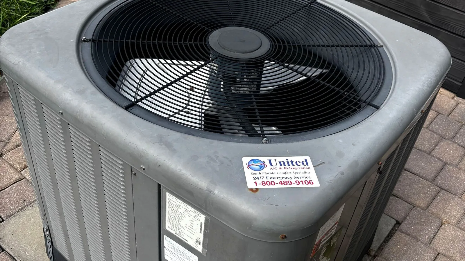 Technician ladder beside a residential condensing unit during a service visit
