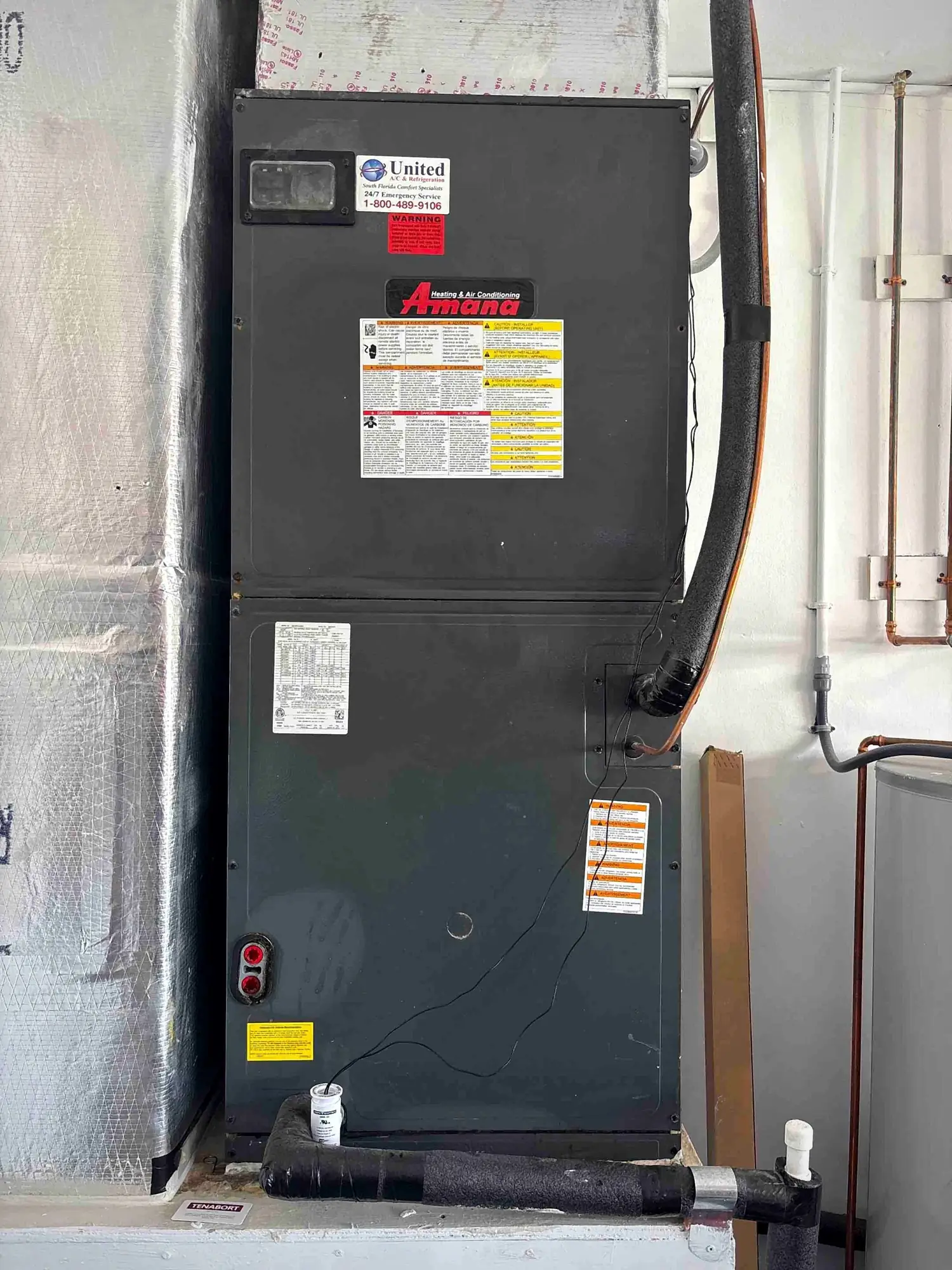 Amana air handler installed in a utility closet with insulated line set and ducted return