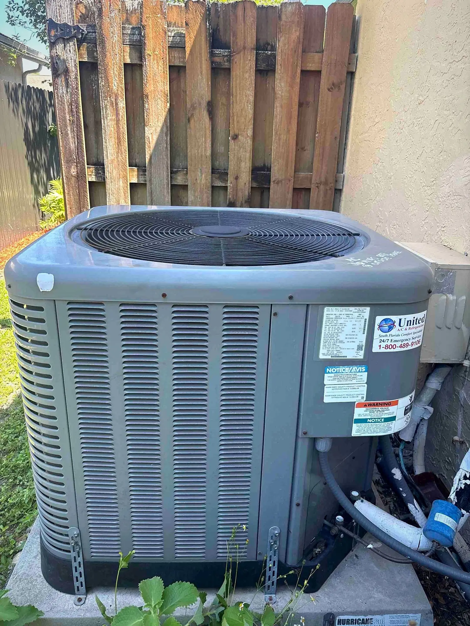 Condenser mounted on a hurricane-rated equipment pad with code-approved product labeling
