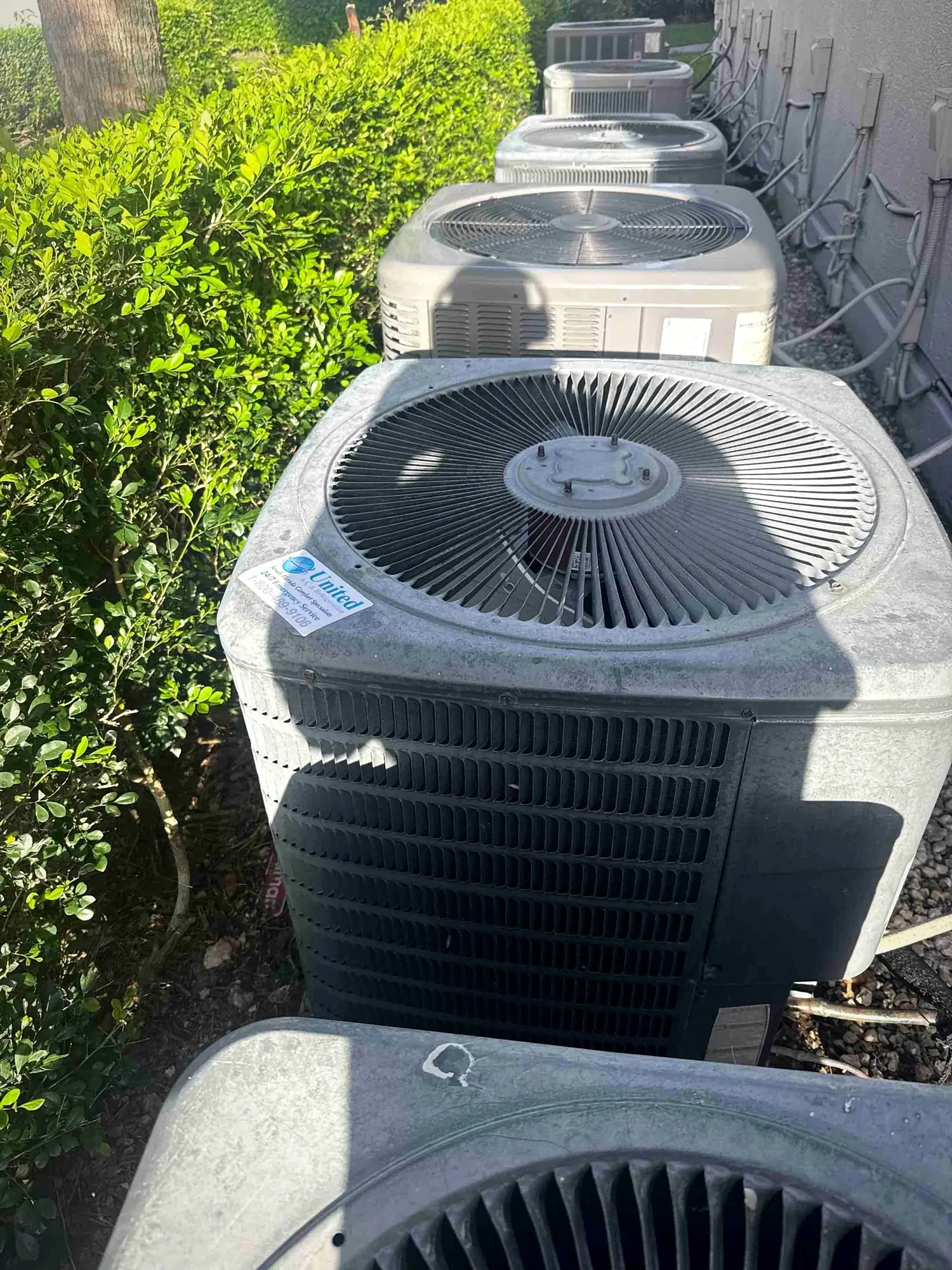 Row of condenser units in a service alley at a multi-family property