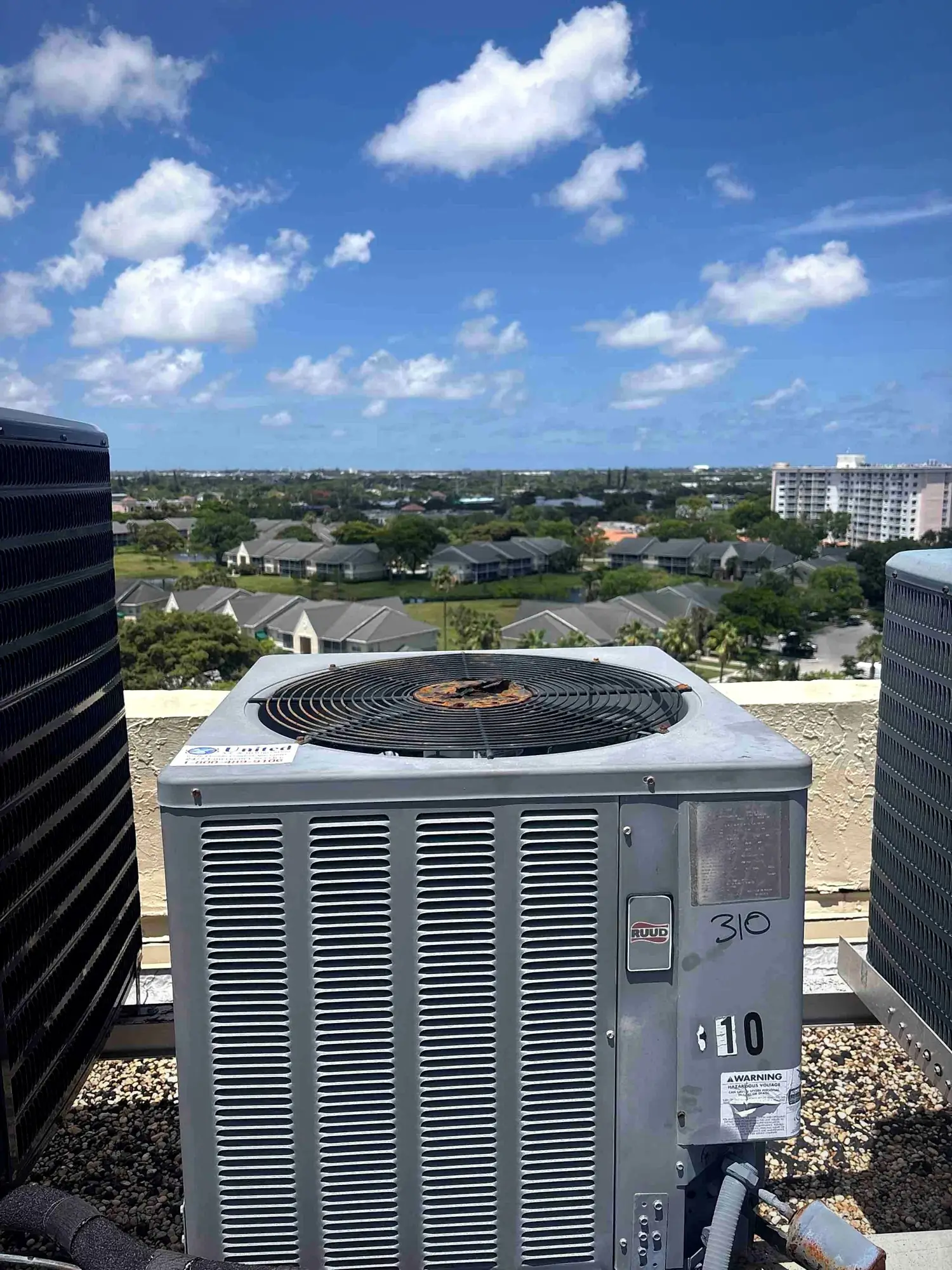 Rooftop condensing unit above a residential community with units numbered for each apartment