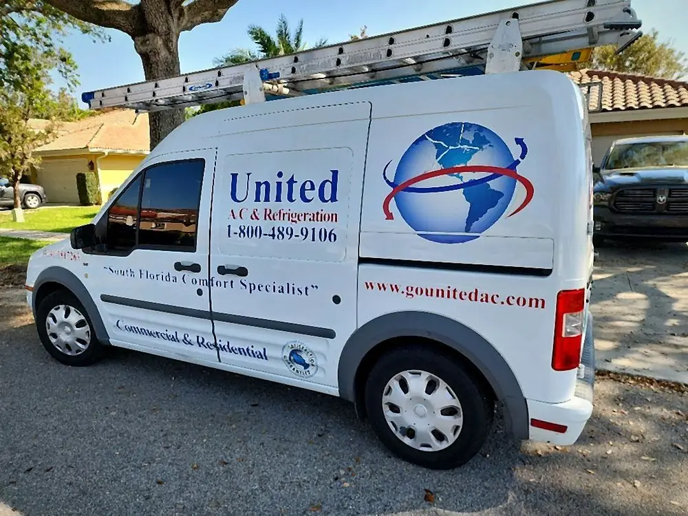 United A/C and Refrigeration van with extension ladders parked at a service call