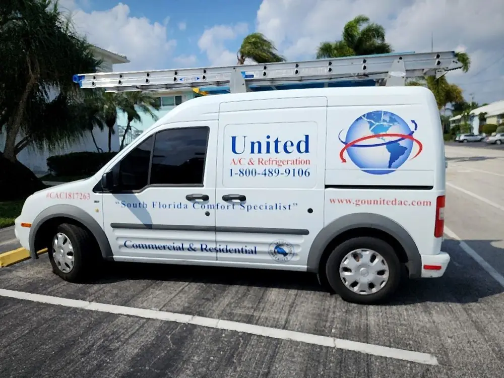 United A/C and Refrigeration service van with roof ladders parked under palms