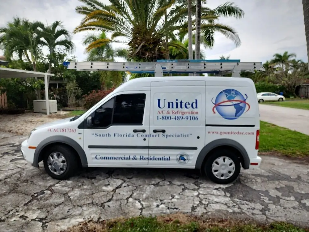 United A/C and Refrigeration service van with ladder rack at a residential job